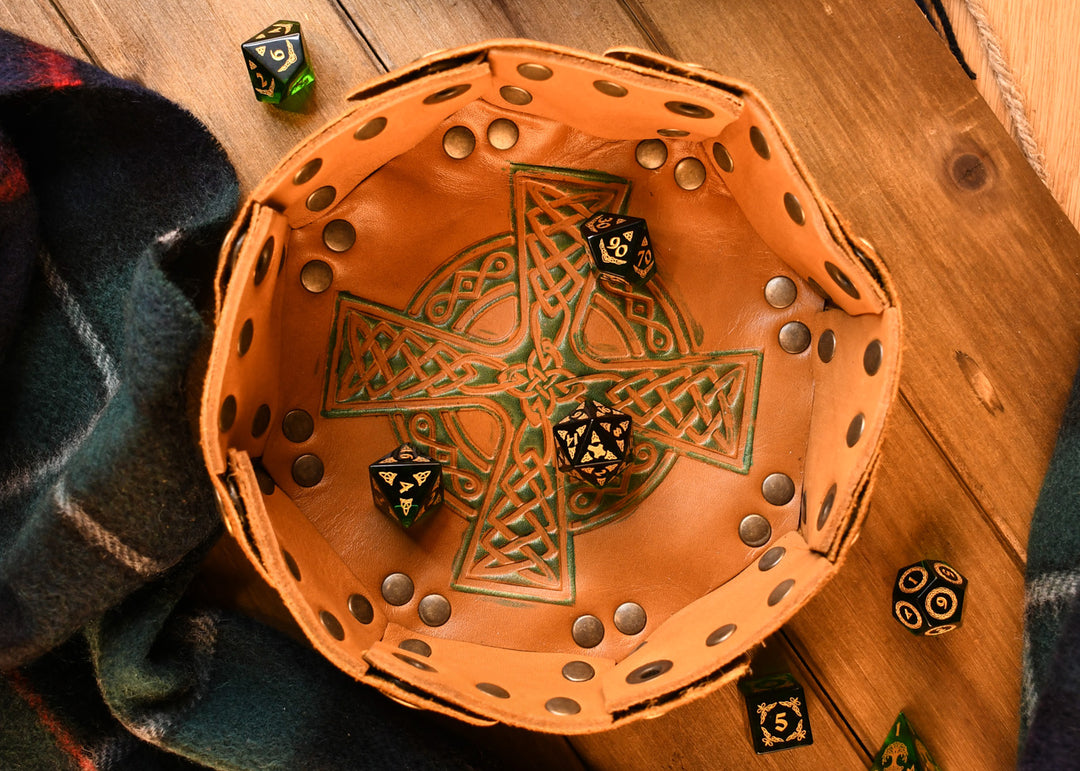 a set of polyhedral Celtic Green Glass Dice with golden numbering and celtic designs on leather celtic dice tray