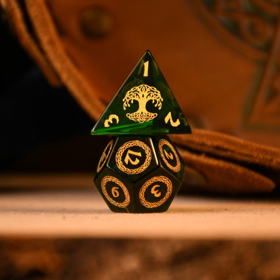 a set of polyhedral Celtic Green Glass Dice with golden numbering and celtic designs