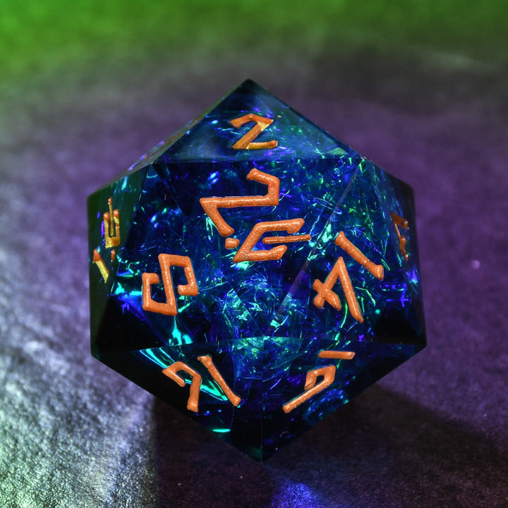 A hand-crafted, sharp-edged resin dice with hand-painted numbers, predominantly blue in color, used for tabletop RPG games.