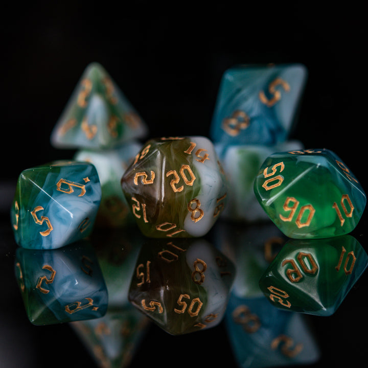 A set of multicolored acrylic dnd dice with engraved numbers, displayed on a reflective surface.