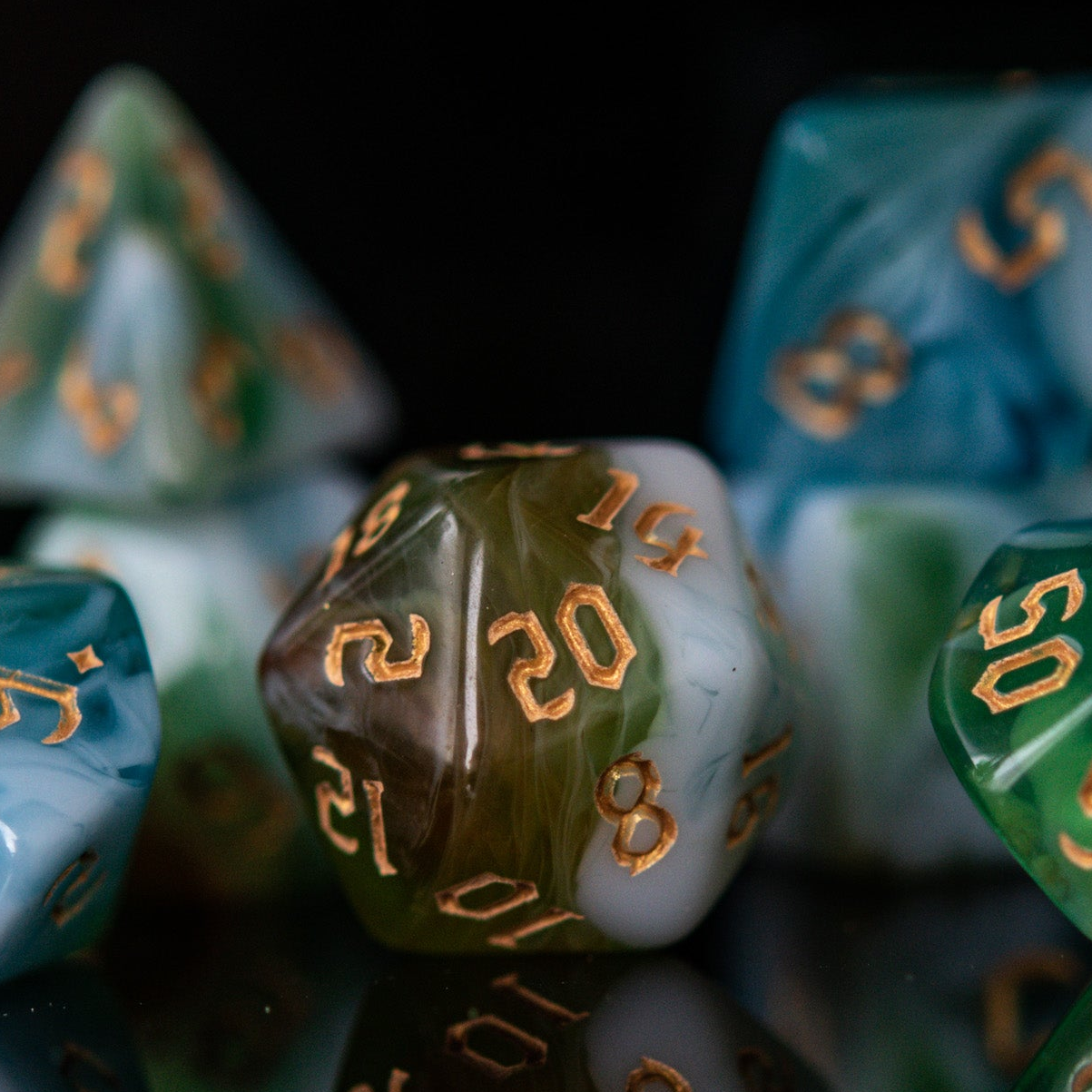 A set of multicolored acrylic dnd dice with engraved numbers, displayed on a reflective surface.