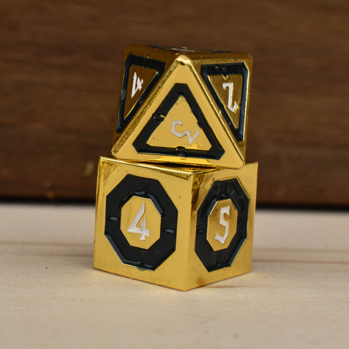 gold polyhedral metal dnd dice with black borders on each face and white numbering