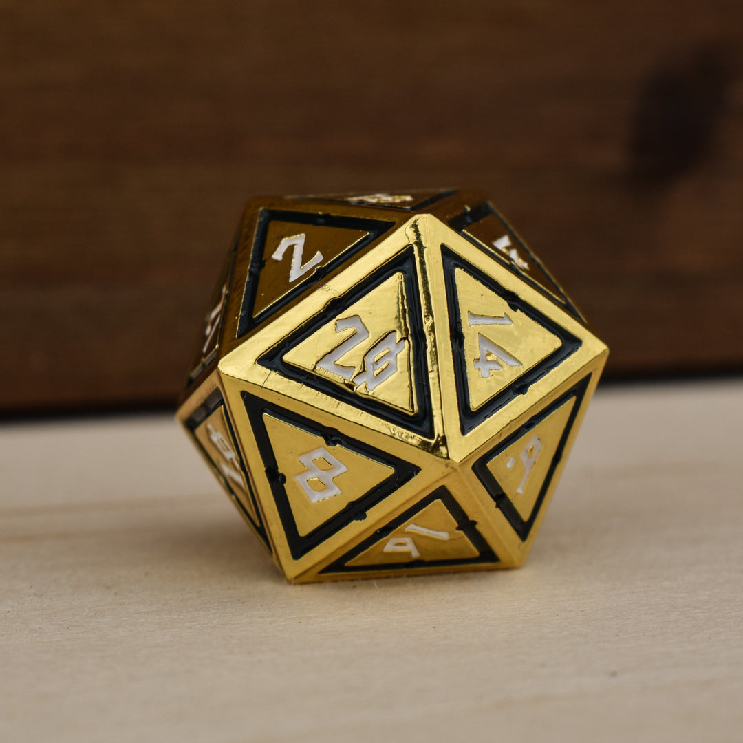 gold polyhedral metal dnd dice with black borders on each face and white numbering