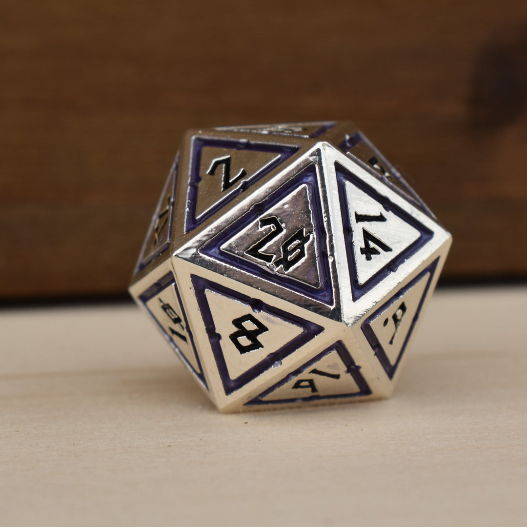 A set of silver polyhedral metal dnd dice with deep purple borders on each face and black numbering