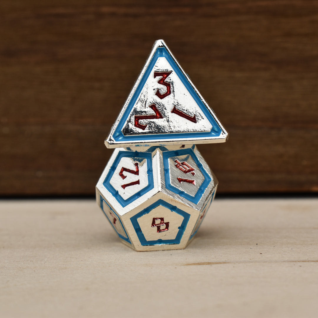 silver polyhedral metal dnd dice with blue borders on each face and red numbering