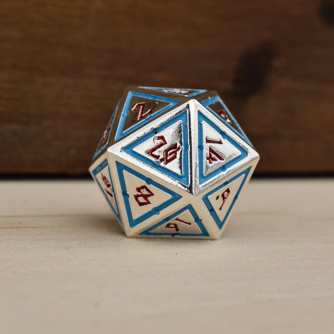 silver polyhedral metal dnd dice with blue borders on each face and red numbering