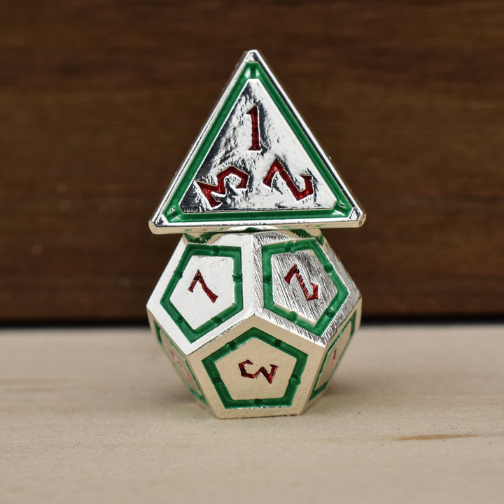  silver polyhedral metal dnd dice with green borders on each face and red numbering