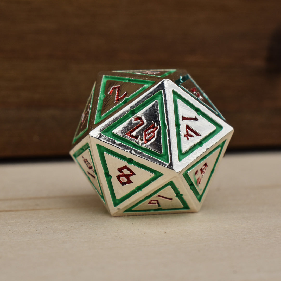 silver polyhedral metal dnd dice with green borders on each face and red numbering
