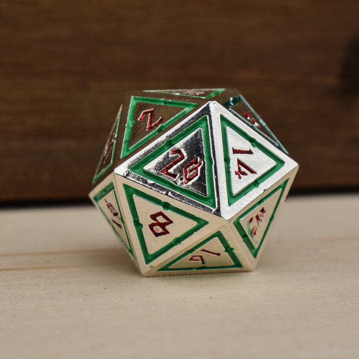 silver polyhedral metal dnd dice with green borders on each face and red numbering