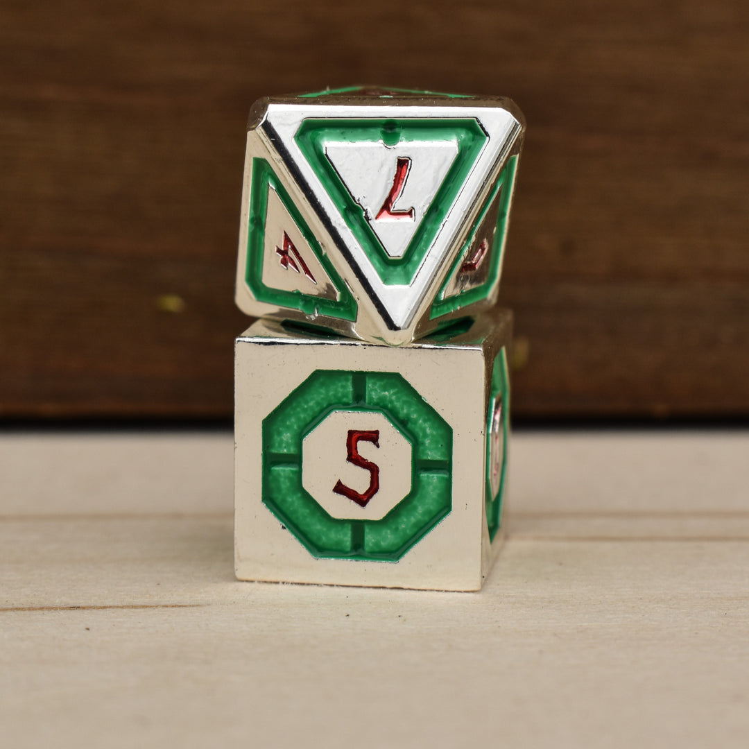 silver polyhedral metal dnd dice with green borders on each face and red numbering