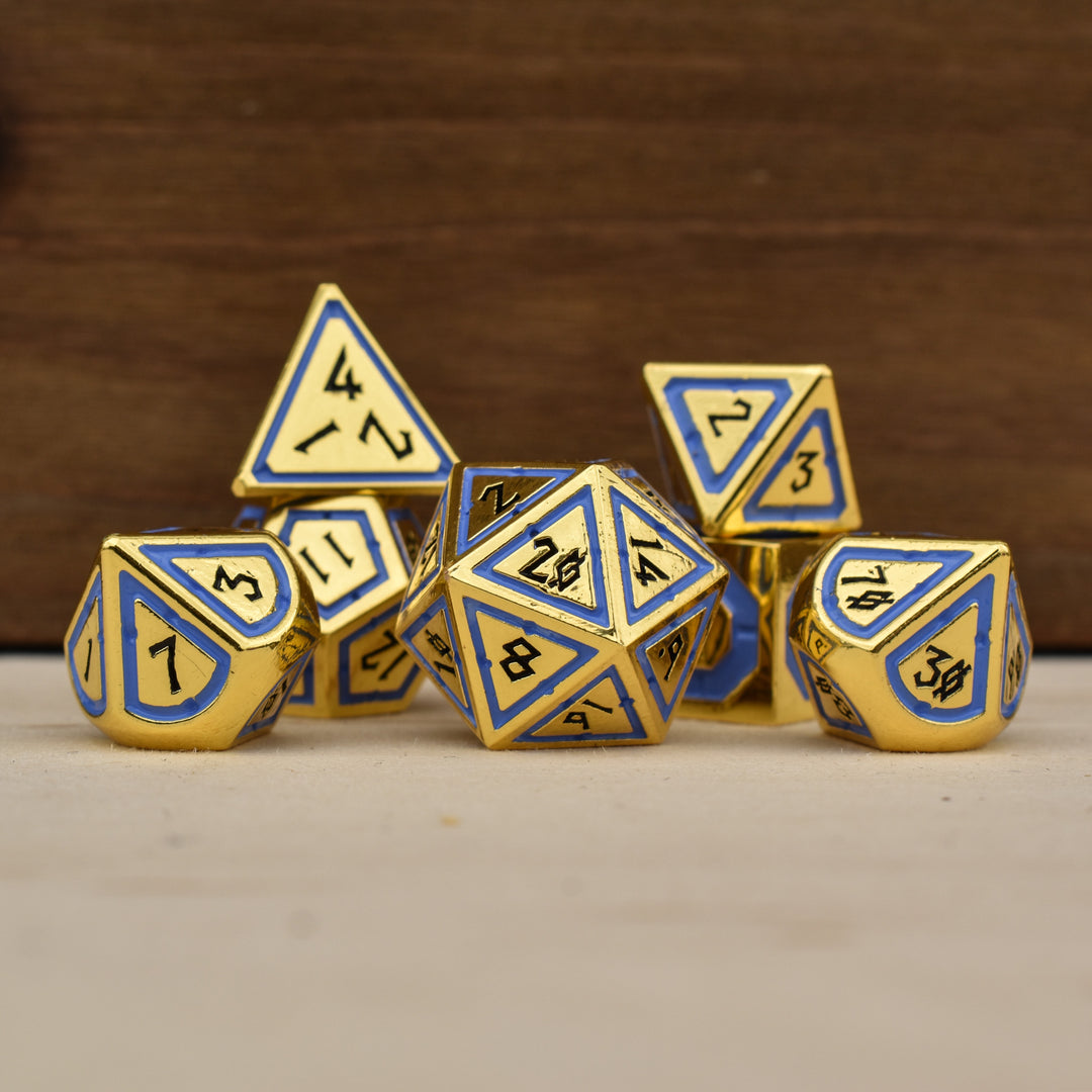 A set of gold polyhedral dnd dice with blue borders on each face and black numbering
