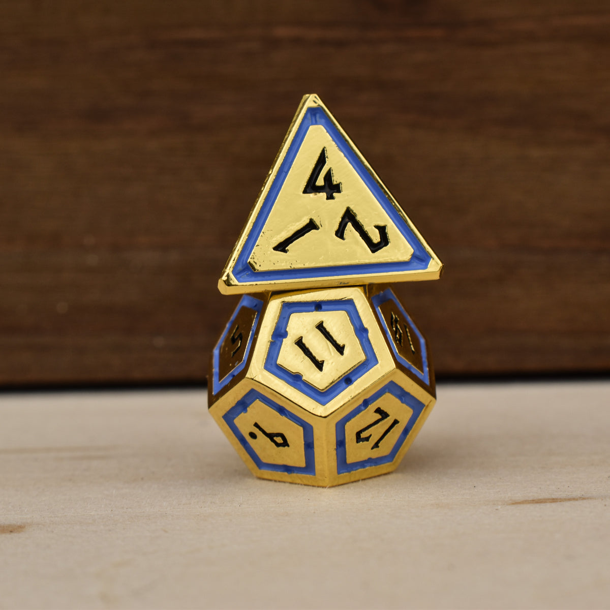 gold polyhedral dnd dice with blue borders on each face and black numbering