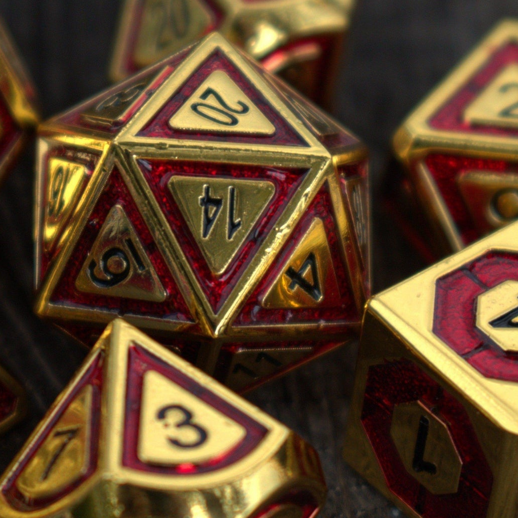 Close-up of gold and red polyhedral dice with numbers and symbols.