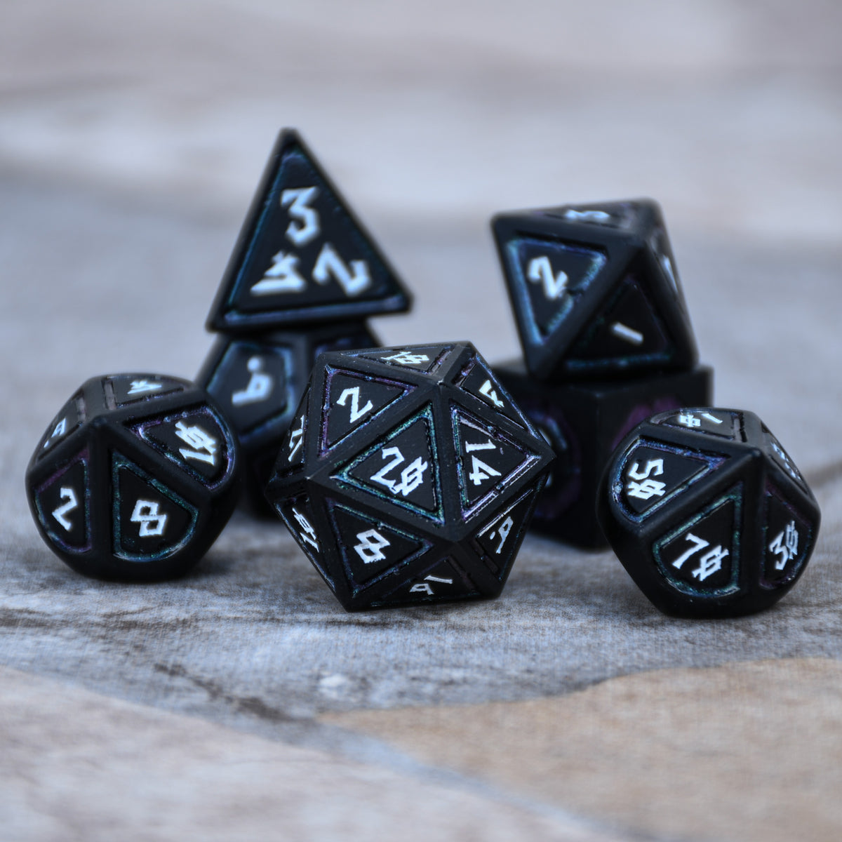 black metal dnd dice with white numbers and dark iridescent borders on each face for dnd and ttrpg