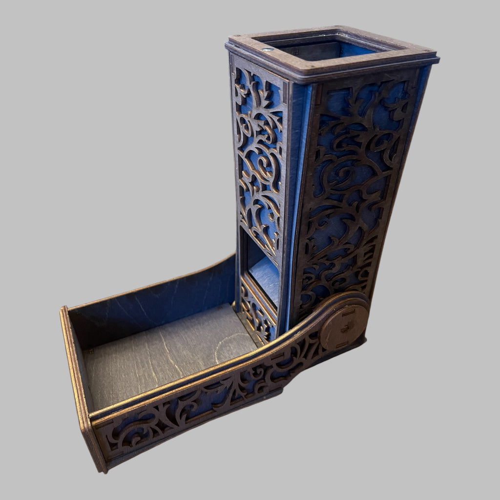 A collapsible blue dice tower with intricate patterns, made of wood, with a magnetic drawer.
