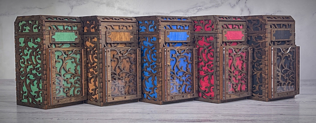 A wooden deck box with a intricate carved design, featuring a removable magnetic plate on the front for holding cards from the game &