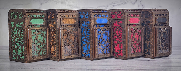 A wooden deck box with a intricate carved design, featuring a removable magnetic plate on the front for holding cards from the game &