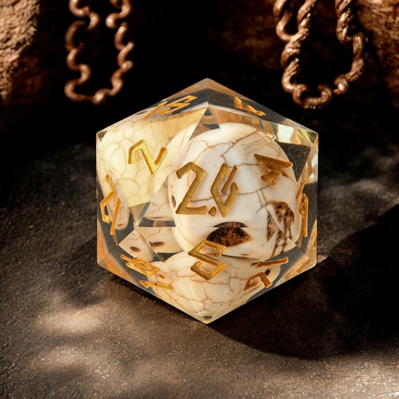 A hand-crafted, hand-painted 30mm resin dice with black, gold, and white colors designed to look like a skull, suitable for tabletop RPG games.
