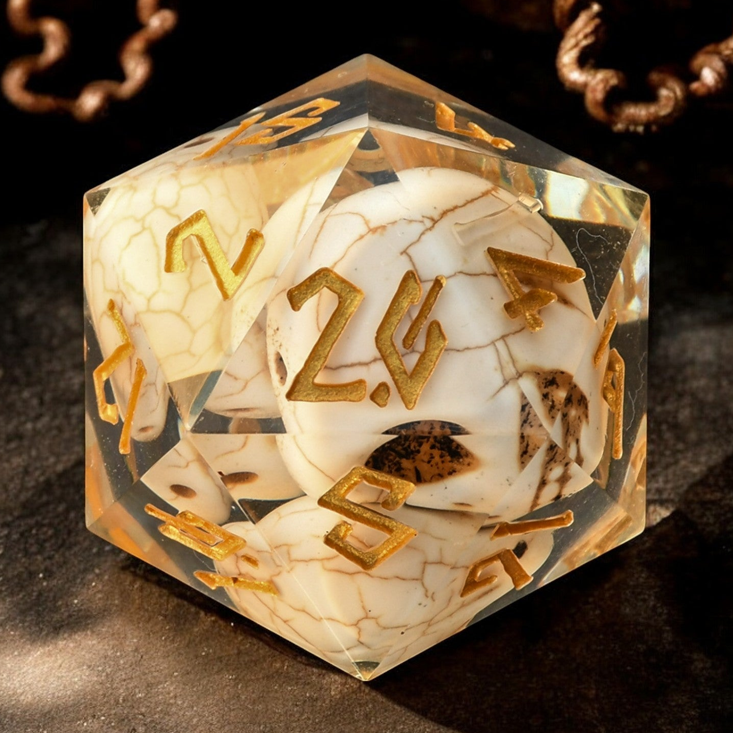 A hand-crafted, hand-painted 30mm resin dice with black, gold, and white colors designed to look like a skull, suitable for tabletop RPG games.