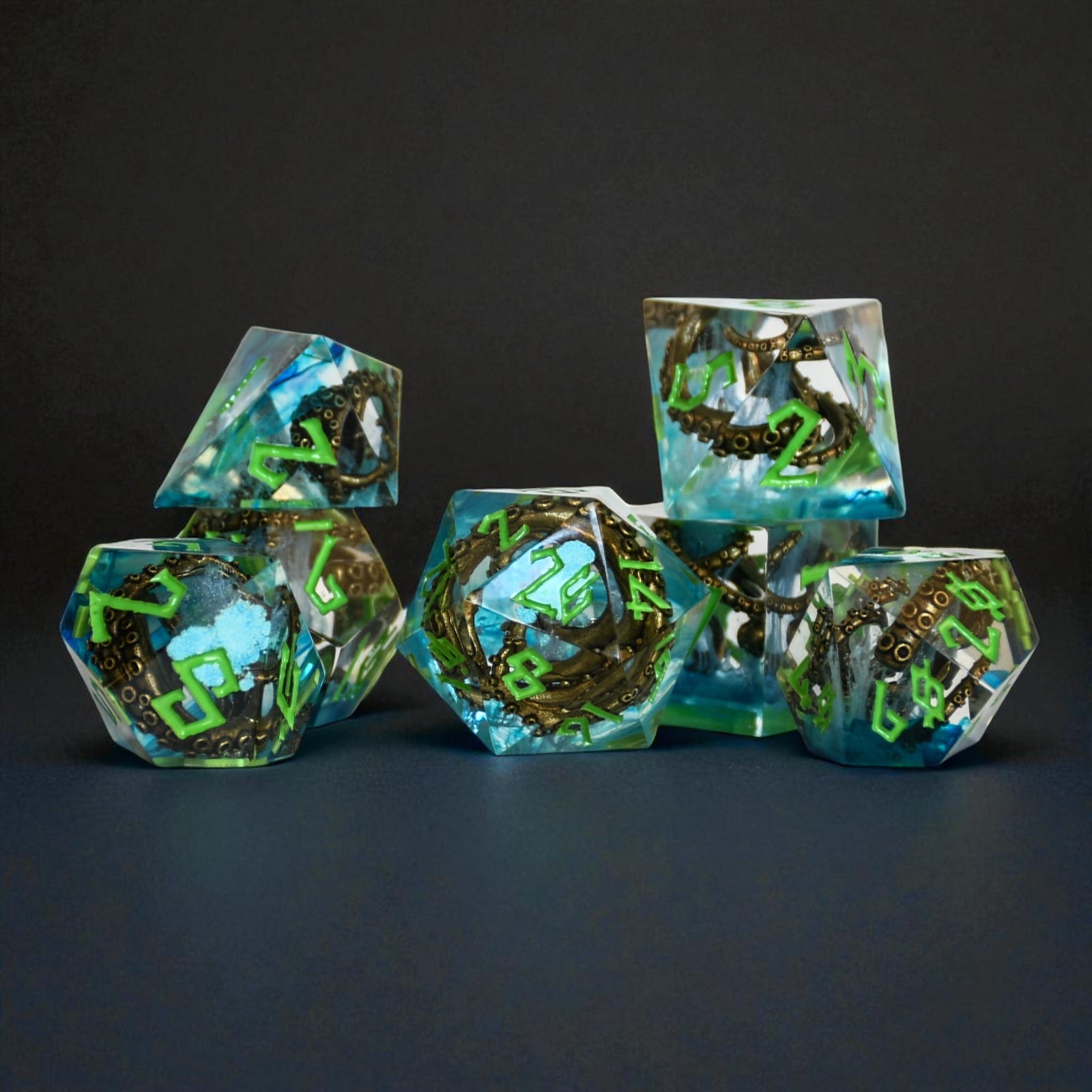 clear resin dice set with blue inside and bronze cthulhu tentacles with green numbering for dnd ttrpg