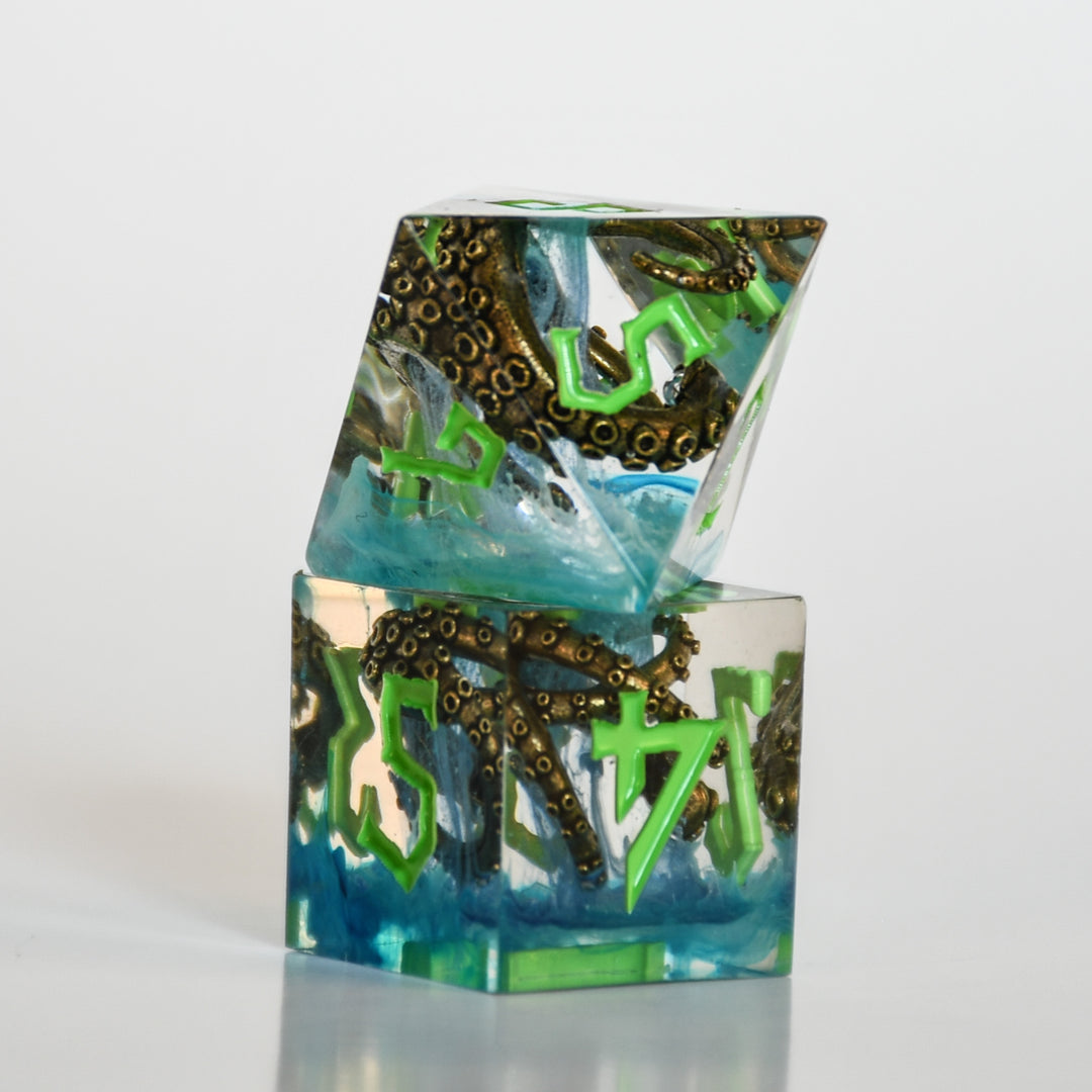 clear resin dice set with blue inside and bronze cthulhu tentacles with green numbering for dnd ttrpg