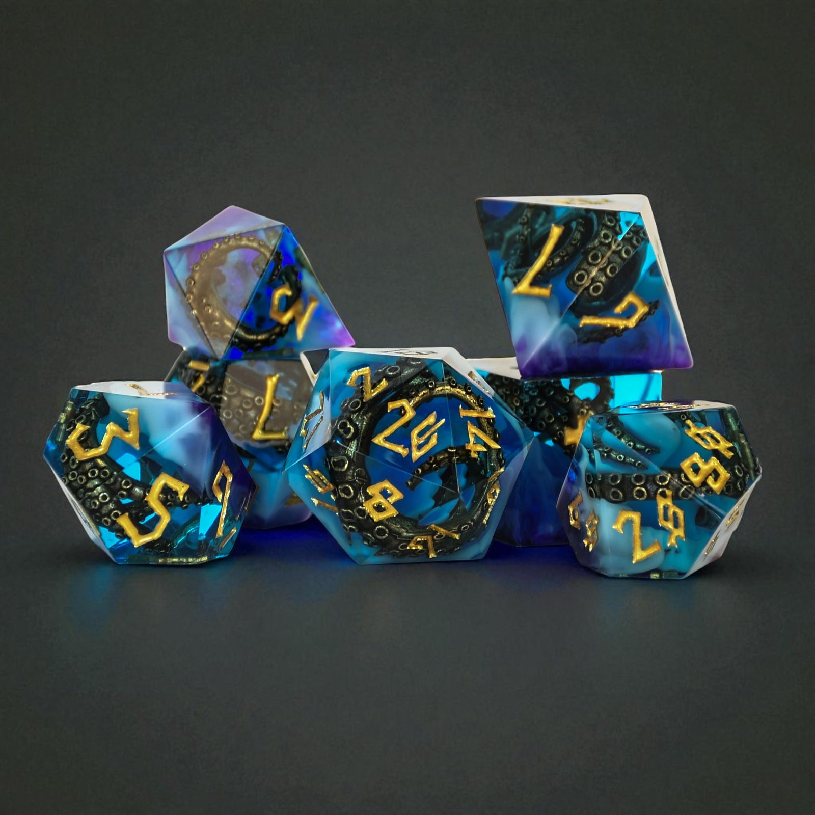 Blue and purple sharp edge resin dnd dice with bronze cthulhu tentacles inside and gold numbering