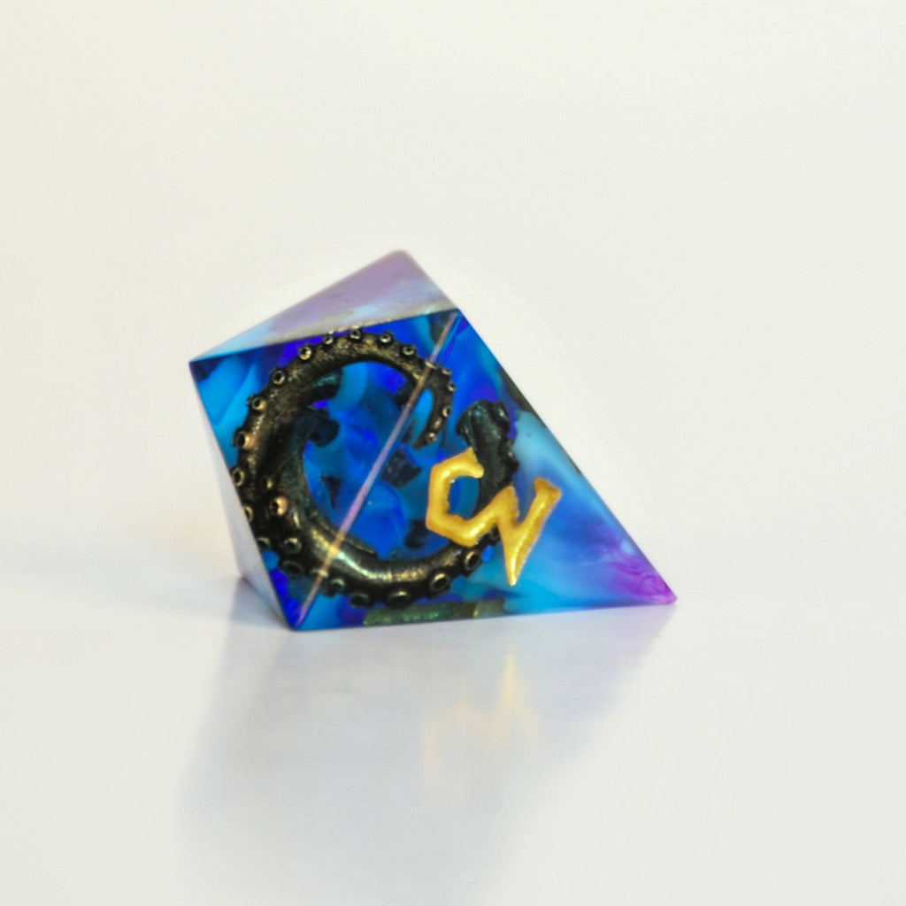 Blue and purple sharp edge resin dnd dice with bronze cthulhu tentacles inside and gold numbering