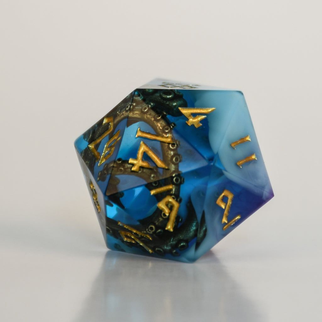 Blue and purple sharp edge resin dnd dice with bronze cthulhu tentacles inside and gold numbering