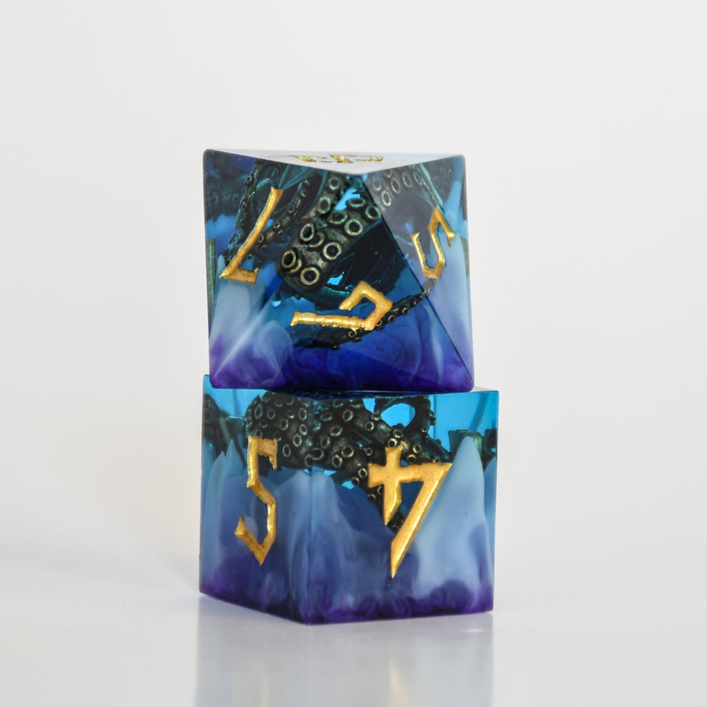Blue and purple sharp edge resin dnd dice with bronze cthulhu tentacles inside and gold numbering