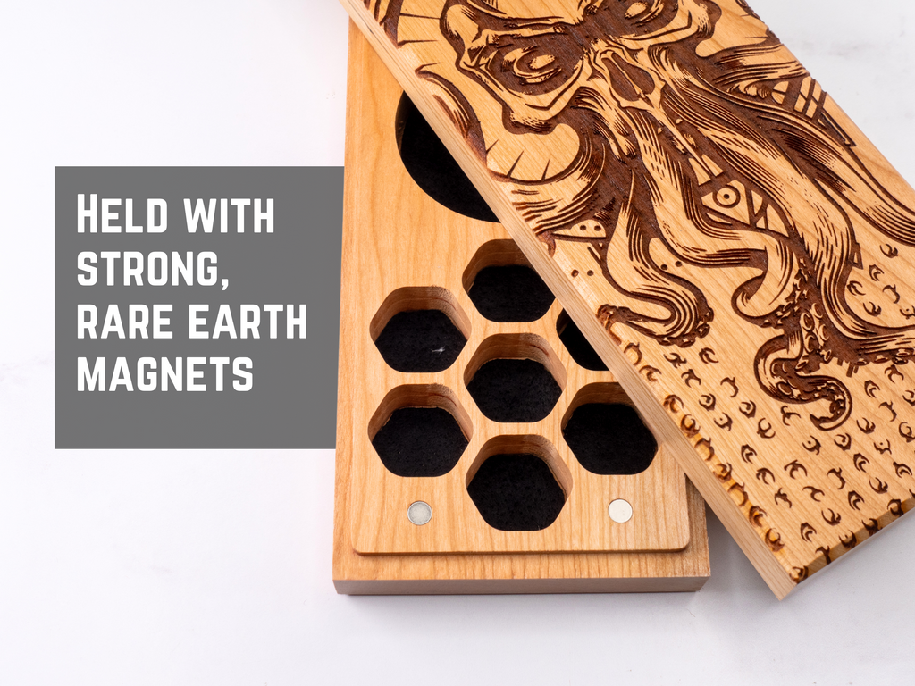 Wooden dice vault with engraved design and text about magnets on a white background