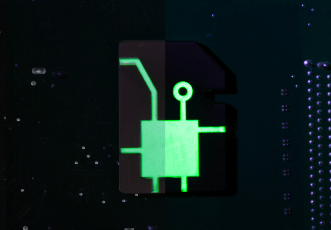 Glowing green circuit-like d2 dice on a dark background