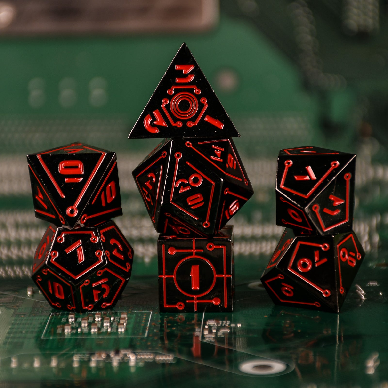 a set of black cyberpunk inspired metal dnd dice with red numbering and detail on a blurry computer chip inspired background