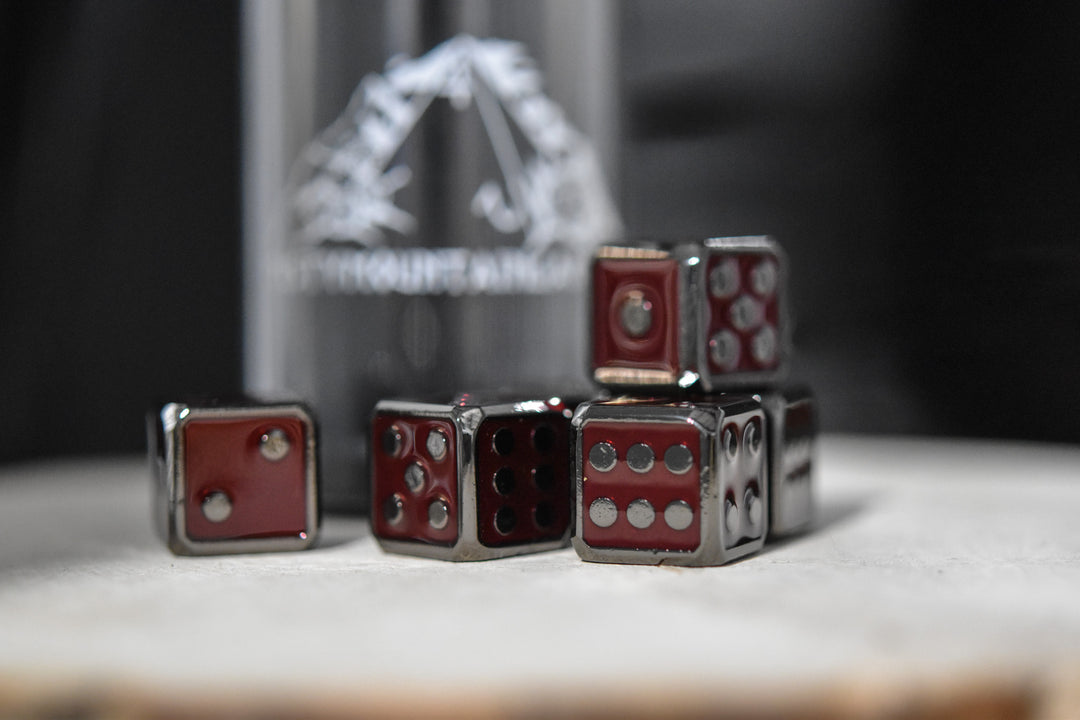 six red and black metal d6 dice with embossed numbers, representing a complete set.