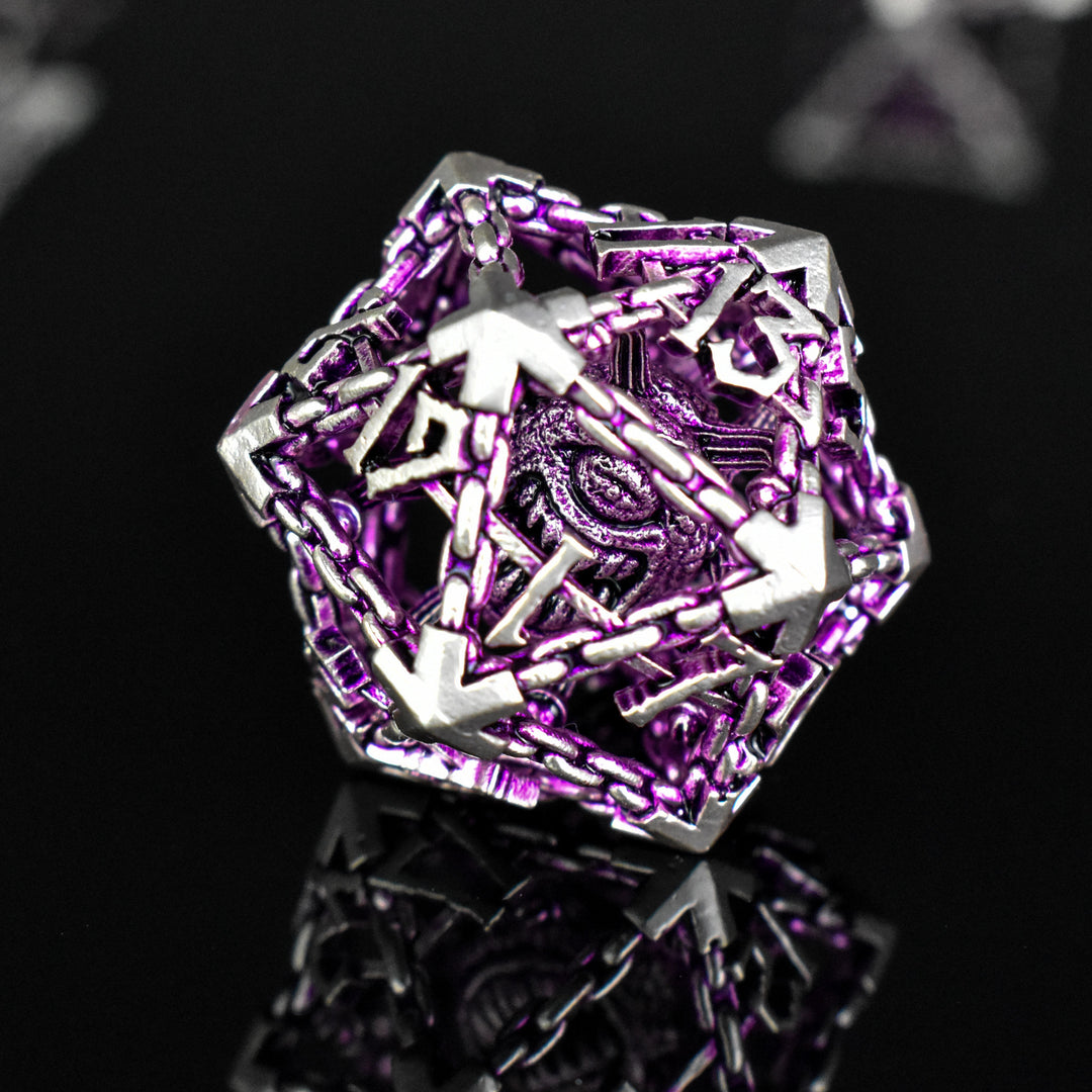 A set of hollow metal dice in purple and silver colors with embossed numbers and a beholder inside, reflecting on a shiny surface.
