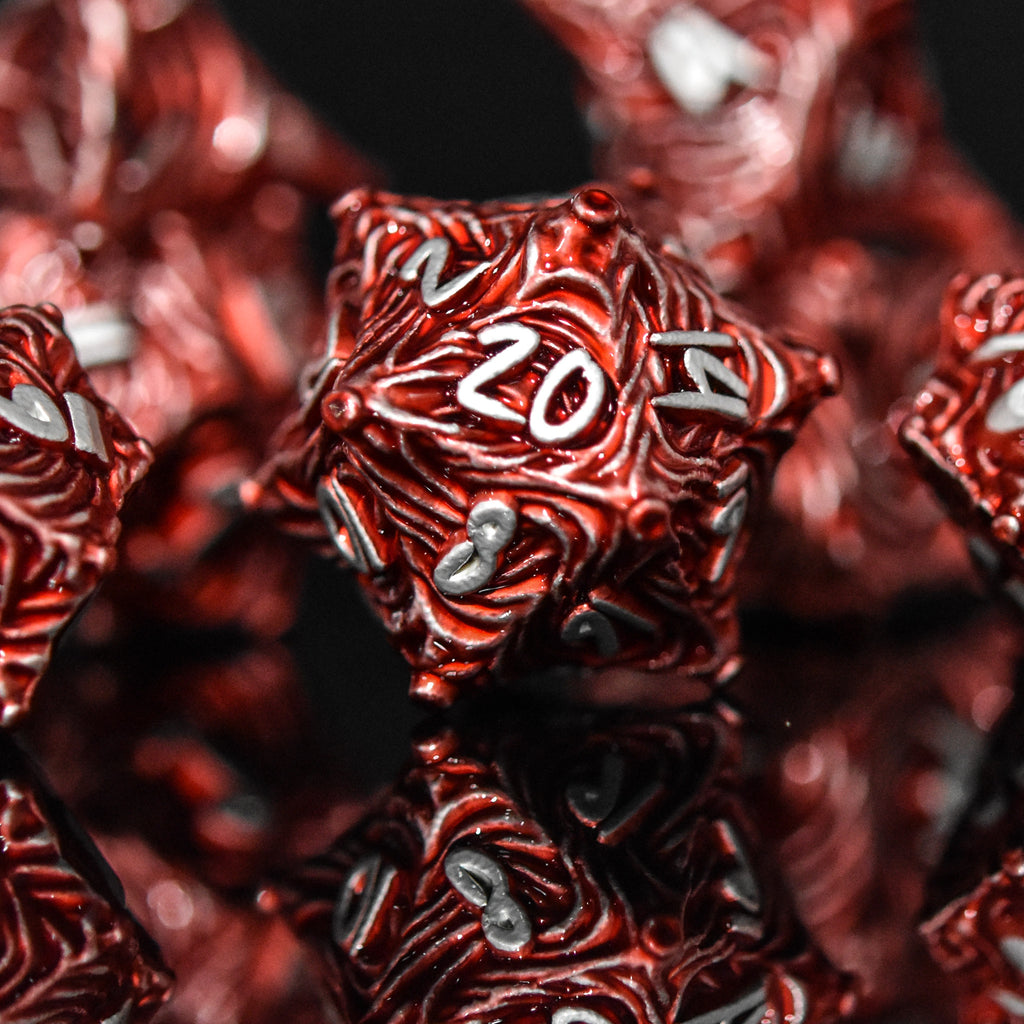 Red metal vortex dice featuring silver font numbers