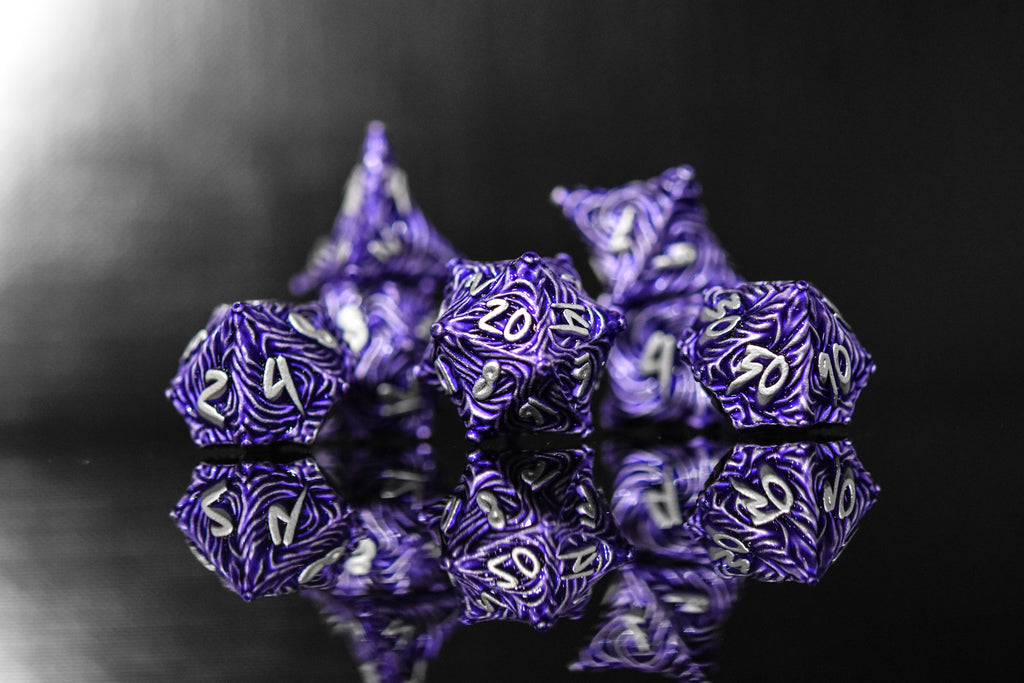 Purple metal vortex dice featuring silver font numbers