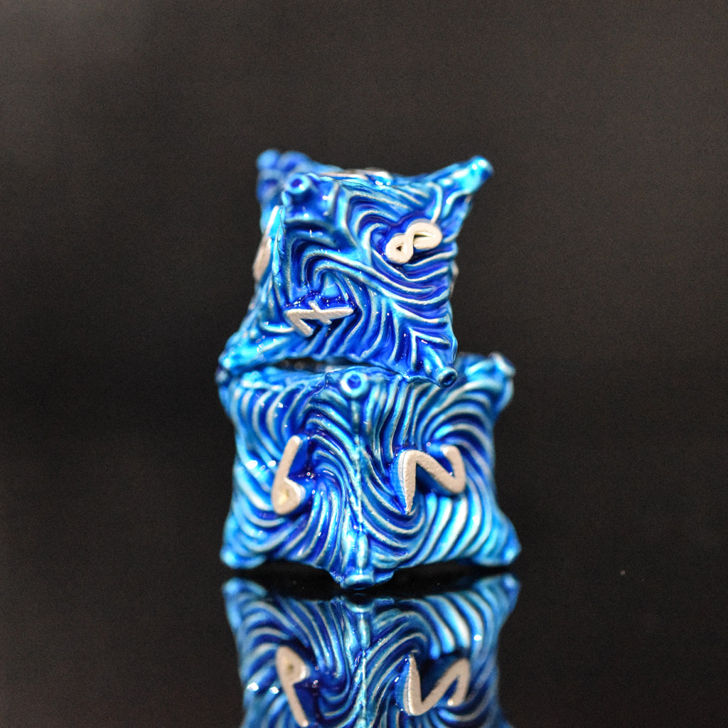 Blue metal dice with vortex swirls and a silver font