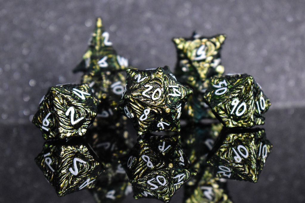 Green pearlescent metal dice with white font numbers