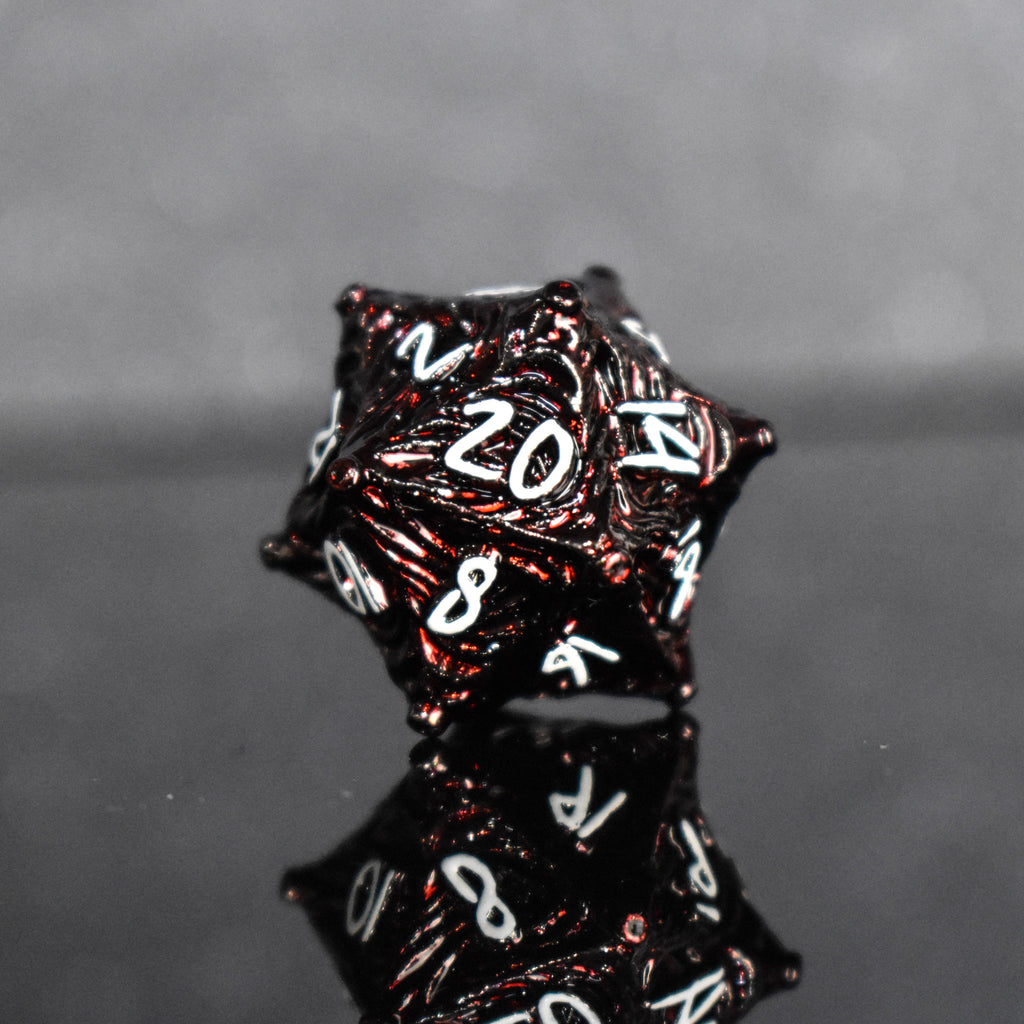 Deep red metal D20 with vortex swirls and a white font