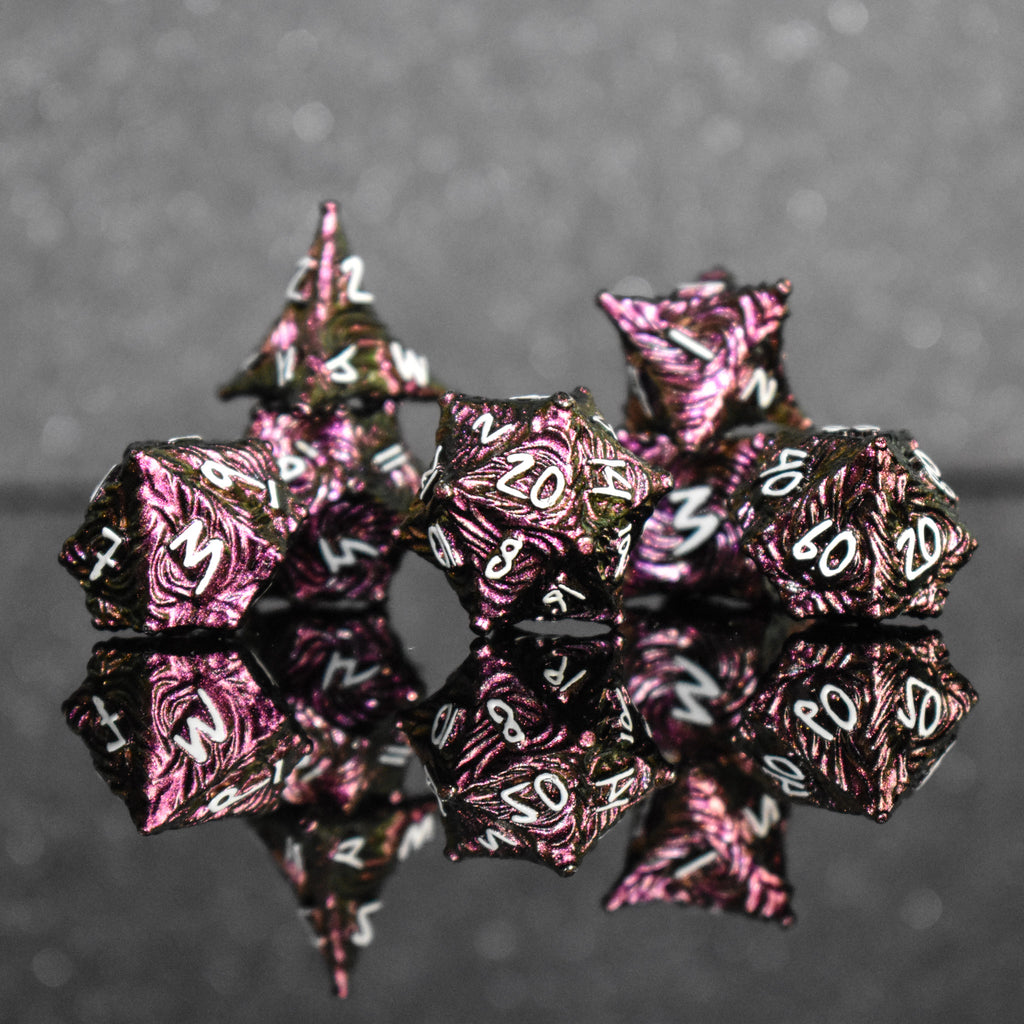 Pearlescent magenta metal vortex dice with white font numbers