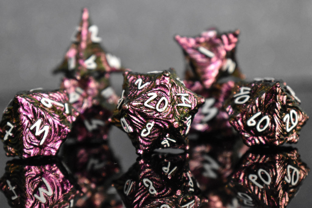 Pearlescent magenta metal vortex dice with white font numbers