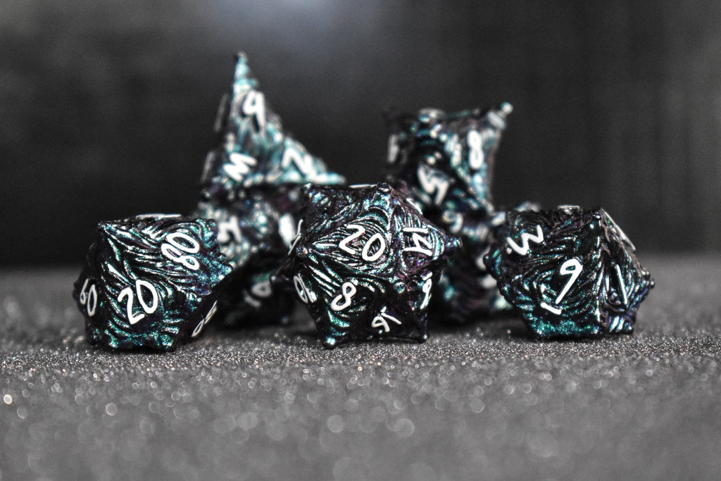 Iridescent galaxy vortex metal dice featuring white font numbers