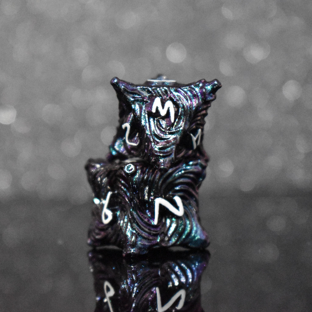 Iridescent galaxy vortex metal dice featuring white font numbers