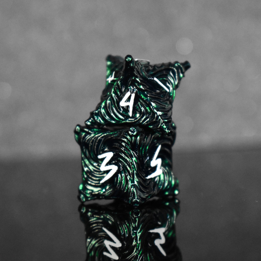 Dark green metal dice with vortex swirls and a white font