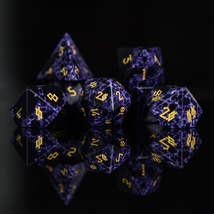 Black stone dice with blue lightning and gold nordic font numbers