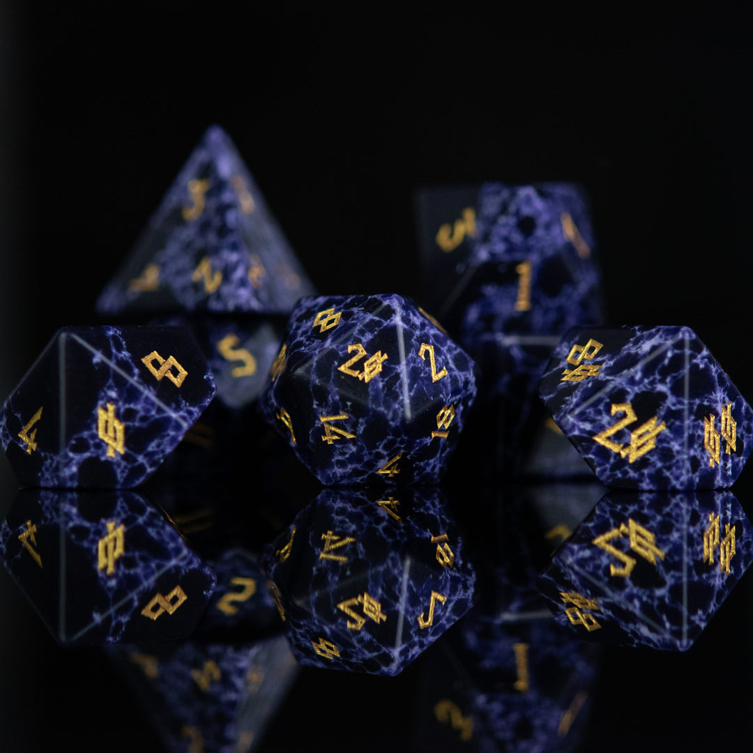 Black stone dice with blue lightning and gold nordic font numbers