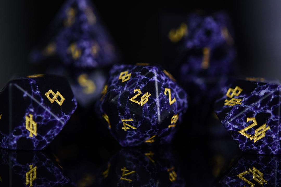 Black stone dice with blue lightning and gold nordic font numbers
