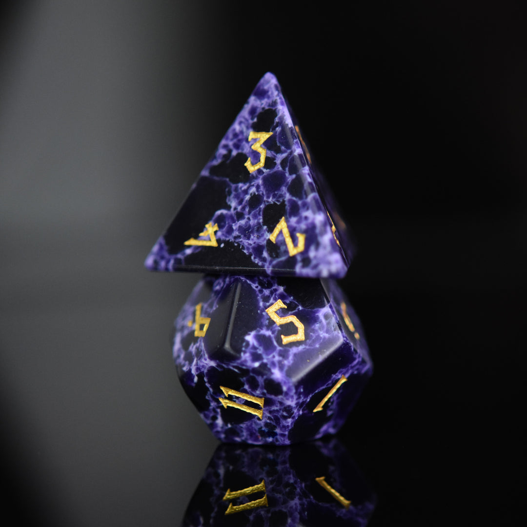 Black stone dice with blue lightning and gold nordic font numbers