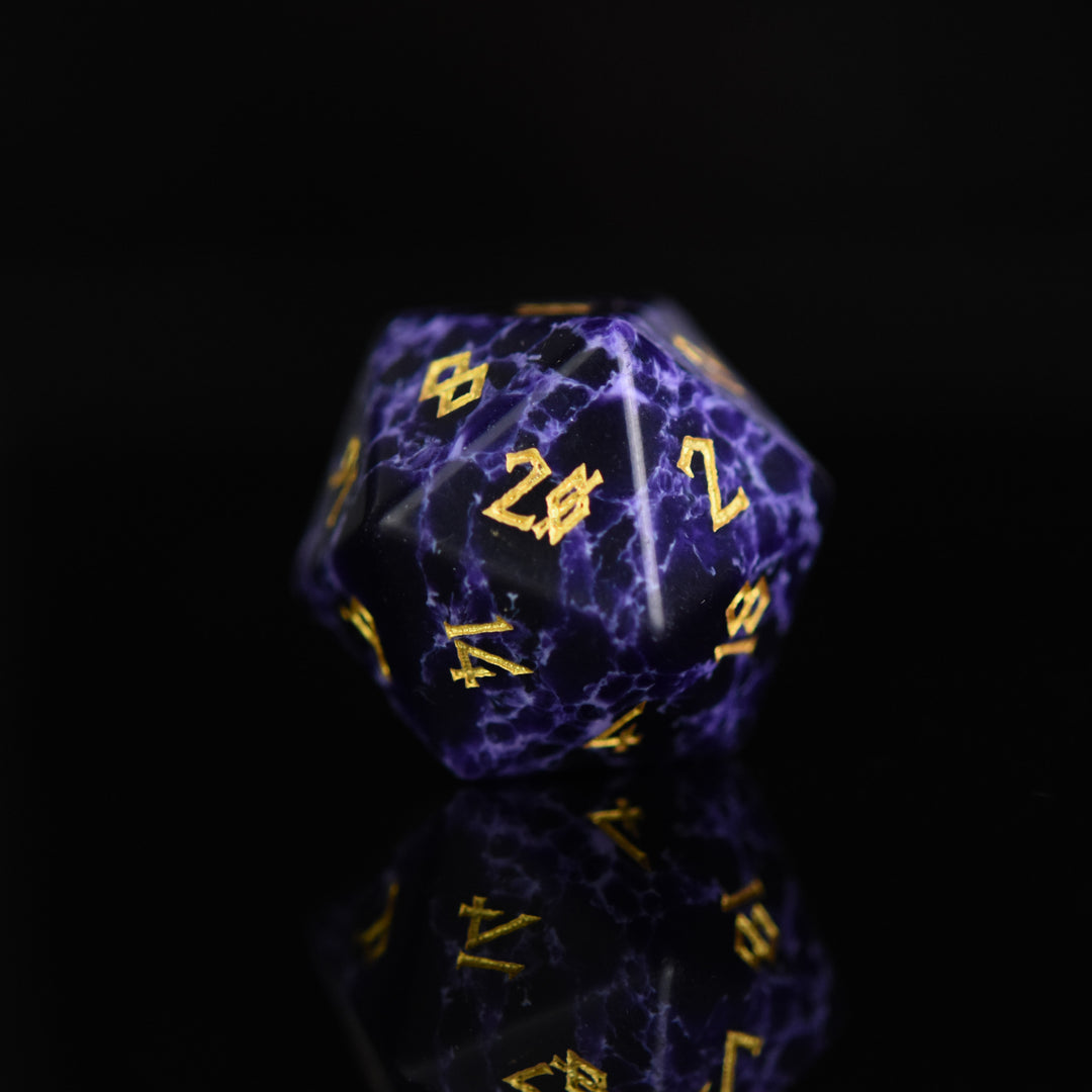 Black stone dice with blue lightning and gold nordic font numbers