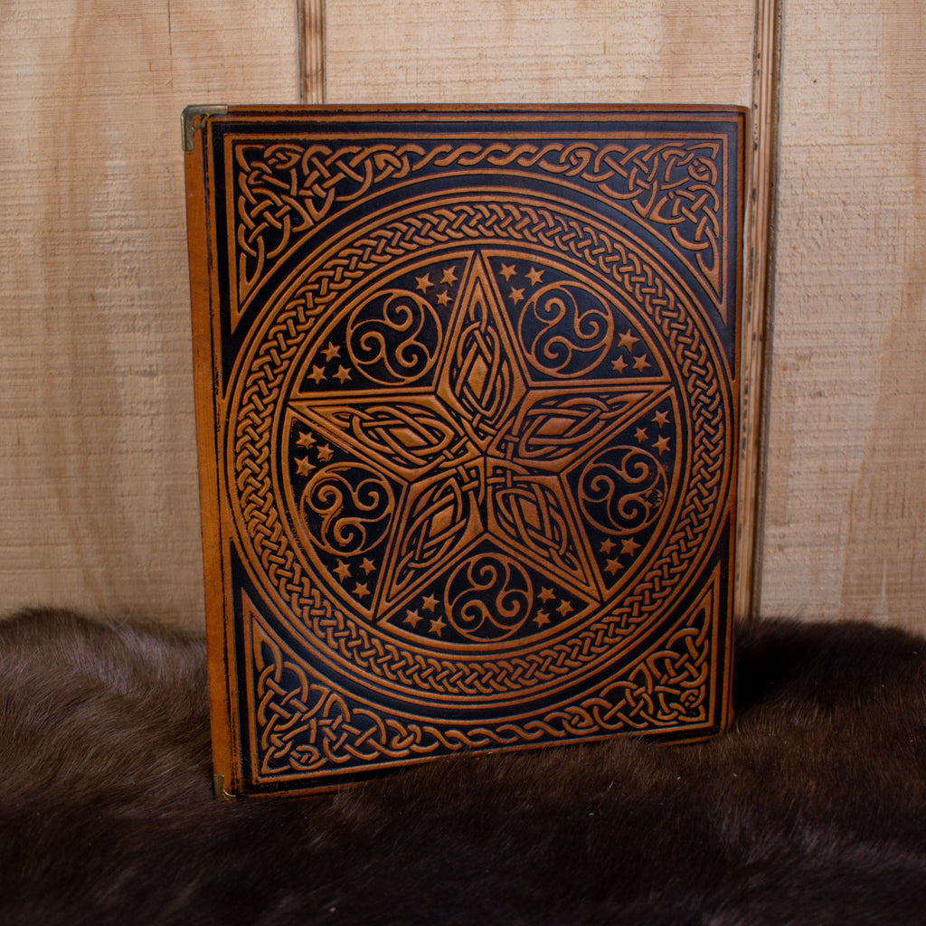 A large tan spell book leather journal featuring a pentacle